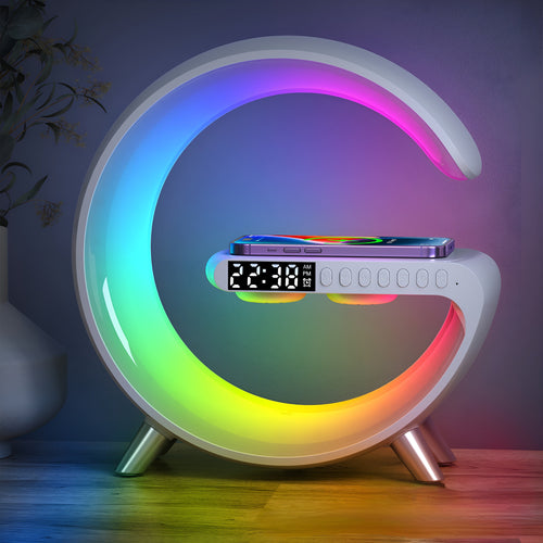 Colorful moon-shaped night light with digital clock and phone stand on a wooden surface.